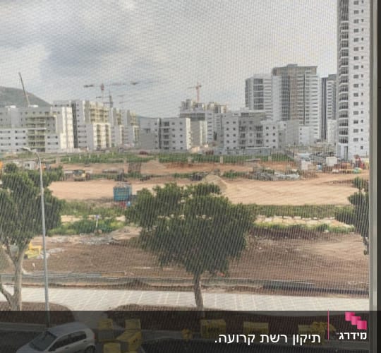 רשת חלון עם נוף עירוני ברקע